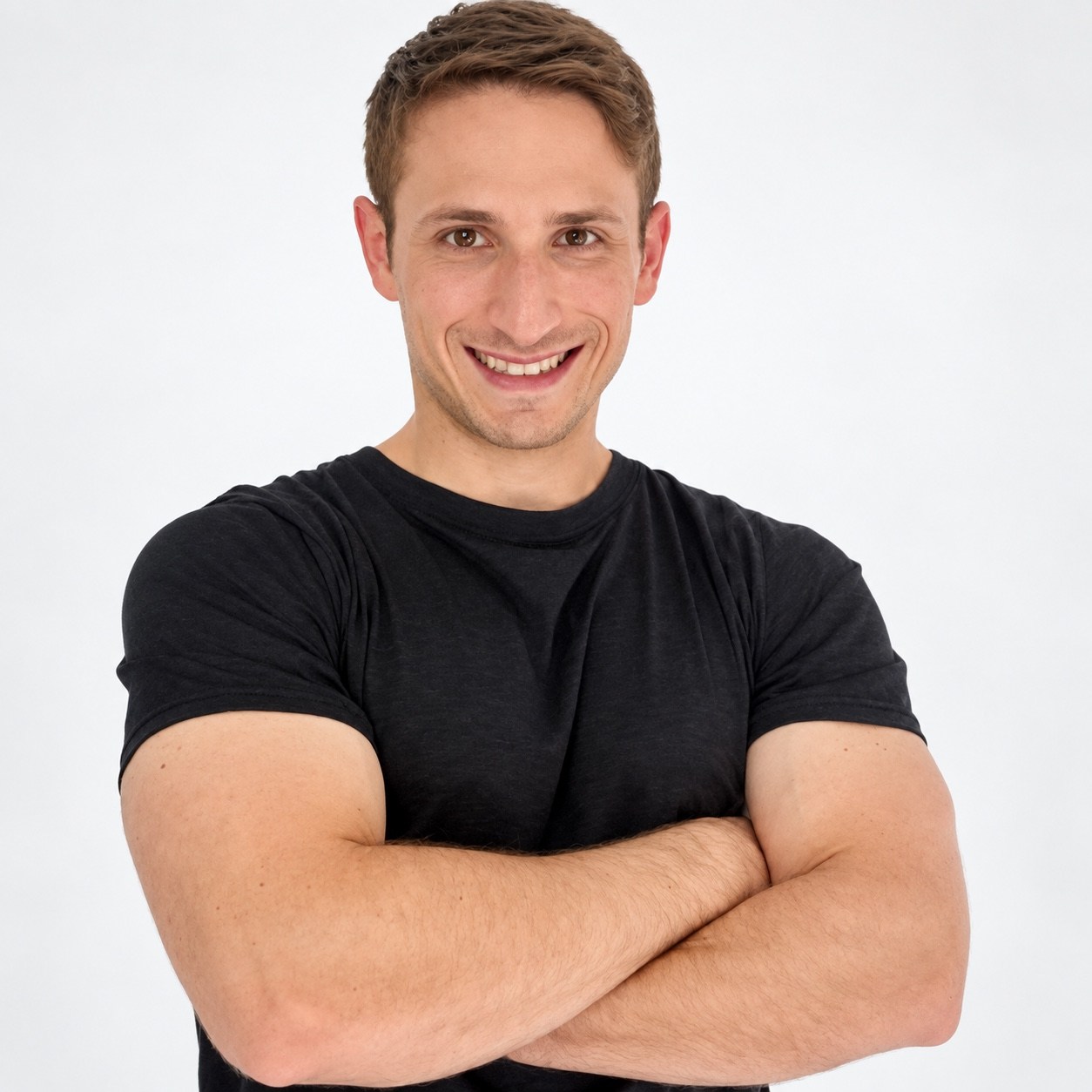 Jack Quint smiling in a black T-shirt with his arms crossed.